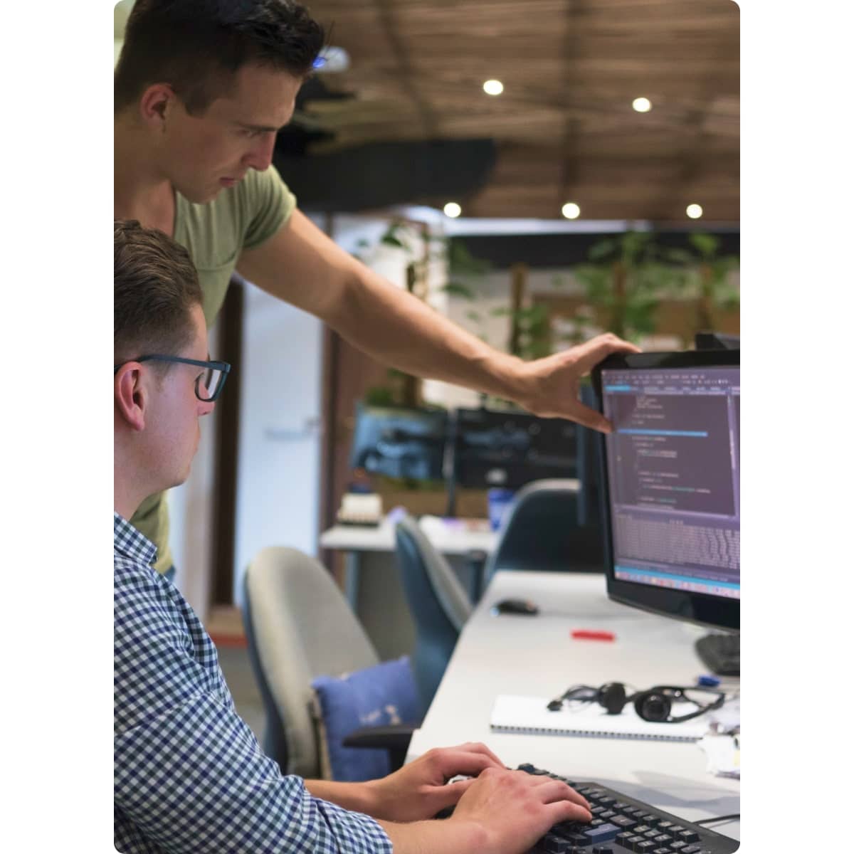 two men looking at screen code software development api